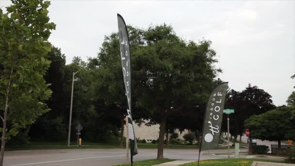 Two Golf Indoor Banner Flag Signs Blowing Wind Next Road — Stock Video