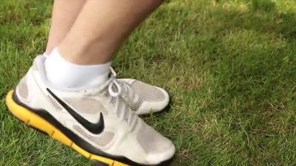 成年男子慢跑时穿着的黄色和黑色白色短袜 在草地上的屏幕上来回跑动 — 图库视频影像