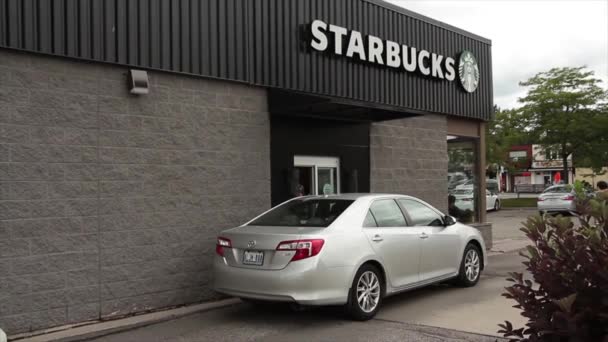 Starbucks Drive Thru Vehicle Pulling Away Another Pulling Window Logo — Stock Video