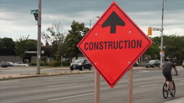 Orange Diamond Portable Construction Sign Wood Posts Traffic Passing Both — Stock Video