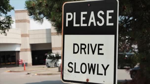 请您慢慢地驾驶 并在车尾的停车场上写上正方形的金属标志 上面写着离开大楼的人 写上黑白相间的大写字母 — 图库视频影像
