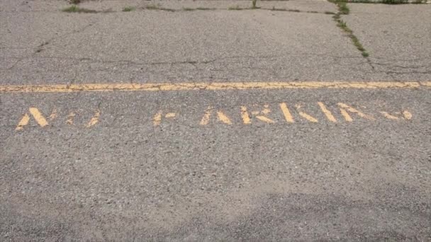 駐車場のキャプションの印刷テキストは パブリックラインの下の黄色で書かれていません 摩耗し 衰えました フレームの上を見下ろしてまっすぐ撮影 — ストック動画