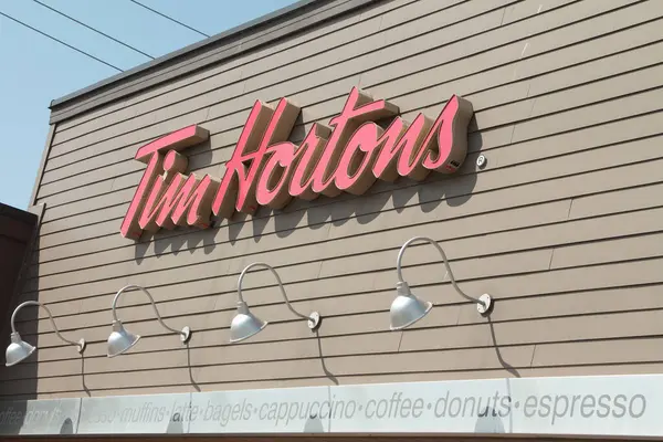 MONTREAL, CANADA - NOVEMBER 6, 2018: Tim Hortons Logo In Front Of One Of  Their Restaurants In Quebec With Their Slogan In French In The Background. Tim  Hortons Is A Cafe And