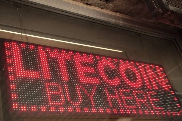 electronic sign litecoin buy here caption writing text cryptocurrency, red lights with black background