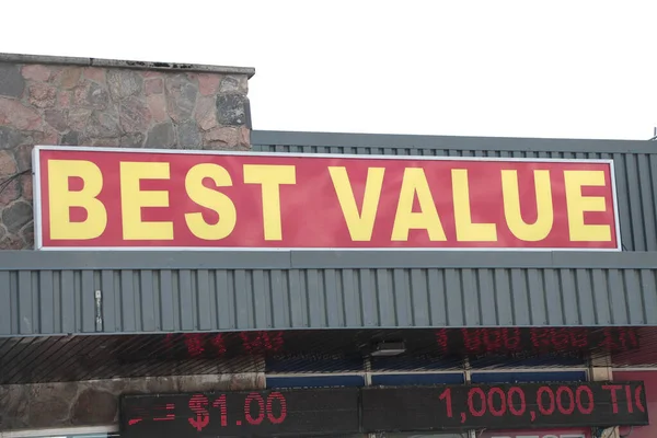 最高の値ワードキャプションテキスト横の長方形のサイン 赤い背景に黄色の店頭に背後にある空とサイン — ストック写真
