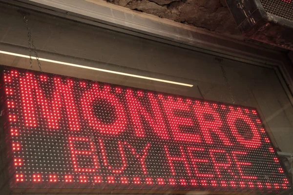 electronic sign monero buy here caption writing text cryptocurrency, red lights with black background