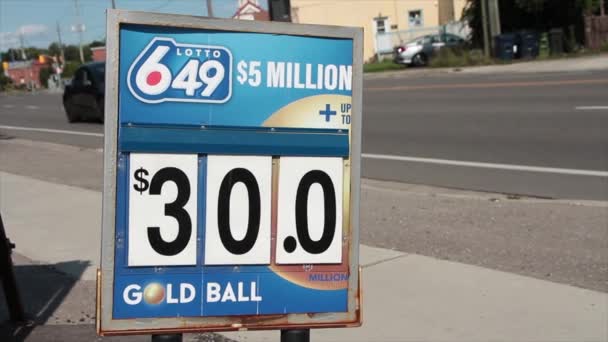 Lotto 649 로고는 빨강에 배경에 방향으로 가벼운 서명합니다 — 비디오