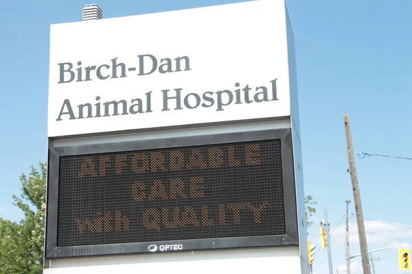 animal hospital front sign with electronic electric digital sign beneath that says affordable care with quality