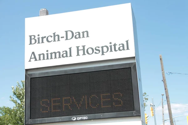 animal hospital front sign with electronic electric digital sign beneath that says services