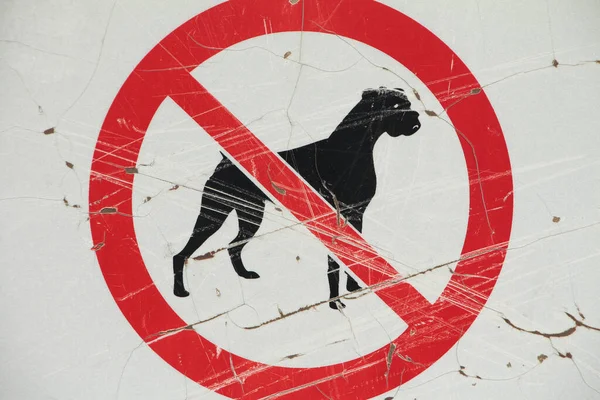 no dogs allowed illustration of a dog crossed out, center centre frame, sign white black and red