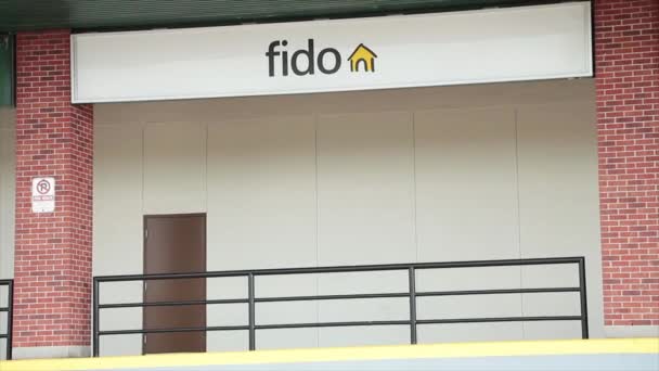 Fido手机服务商店标识立面为水平矩形标志 带有铁栏门框 门框下方有砖柱 — 图库视频影像