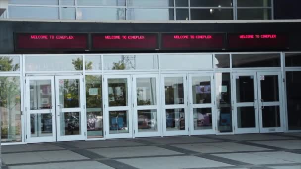 Movie Theatre Theater Entrance Doors Exterior Electric Digital Sign Says — Stock Video