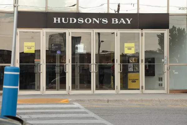 stock image hudsons bay department store front entrance doors with sign logo above them in white and black and windows above them