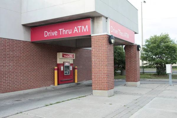 drive thru atm writing caption text red white sign bank machine drive thru with bank machine and no cars in it