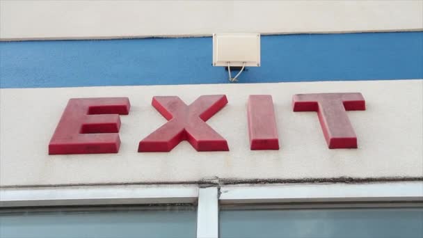Exit Word Caption Writing Text Red Sign Building Wall Windows — Stock Video