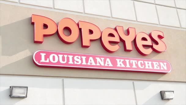 Popeyes Lou Kitchen Orange White Sign Logo Wall Back Restaurant — стоковое видео