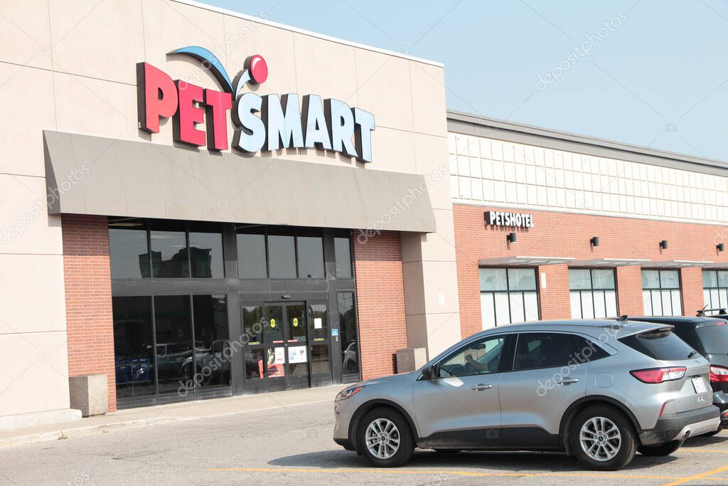 Petsmart petshotel store storefront front entrance with sign logo on front with parking lot and cars in front