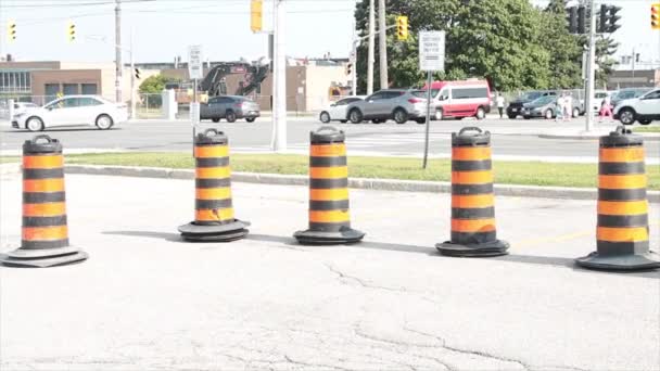 Five Traffic Delineators Drums Barrels Pylons Cylinders Parking Lot Road — Stock Video