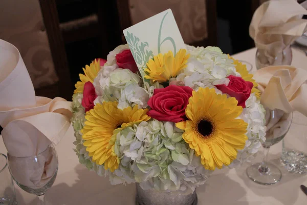 flower bouquet with number six 6 card in it yellow red white in vase on table