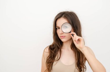 a woman looking through a magnifying glass