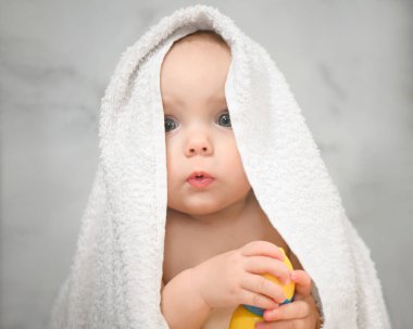 a baby in a white towel after taking a shower