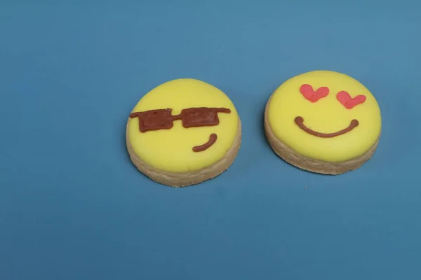 yellow cookies with a smile on a blue background. the concept of happy valentine \'s day