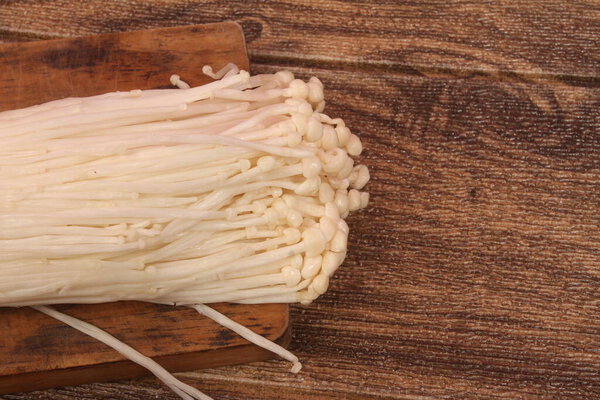 enoki mushroom on wooden table
