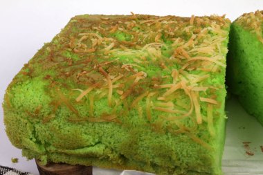 Beyaz arka planda rendelenmiş peynirli yeşil ekmek