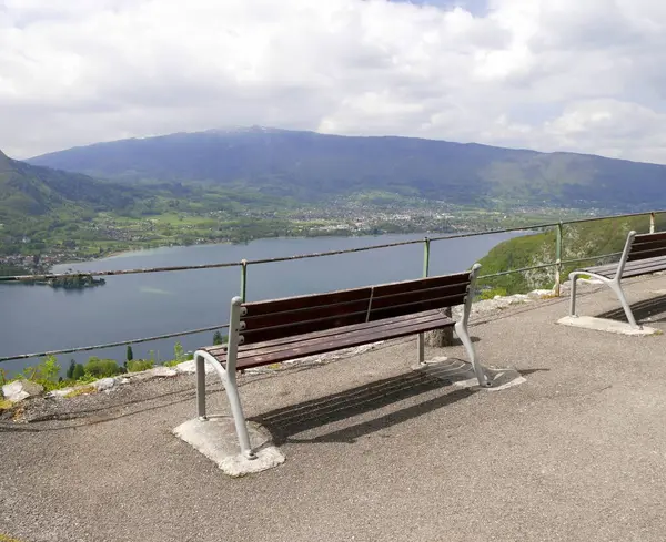 stock image wooden bench with view over semnoz and Annecy lake in Haute savoie, France. Lake view