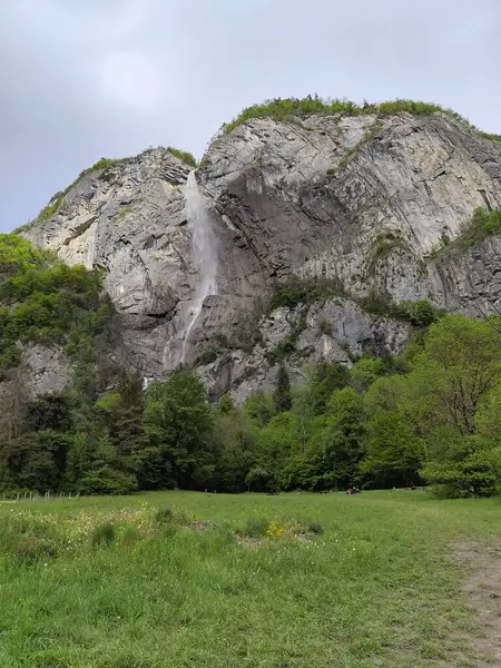 stock image Arpenaz waterfall, one of France highest cascade in Haute Savoie in springtime with impressif cliff of Giffre Massif mountain, alpine landscape