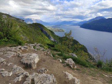 panoramic view of Bourget lake in Chambotte outlook, in haute Savoie, french alps in spring. Dirt path, and landscape in cloudy weather clipart