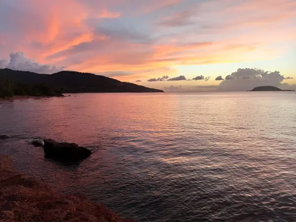 stock image picturesque sunset sky by clugny beach with kahouanne island in the background, basse terre, guadeloupe. Idyllic vacation landscape