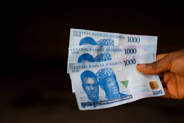 stock image Hand holding money. Banknotes of Nigerian currency in Africa