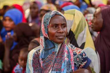 Abuja, Nijerya - 26 Şubat 2023: Covid 19 Toplum Duyarlılığı, Sağlık ve Su Hijyeni. Afrikalılar oturuyor, kuyruğa giriyor ve ücretsiz tıbbi yardım bekliyorlar. Afrika 'daki Seçim Süreci.