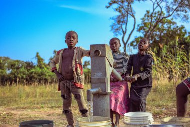 Karara, Nasarawa State, Nigeria - May 5, 2021:Newly Constructed Indian Hand Pump Borewell in a Rural Community in Africa. Running Water from a Community Borehole Water Point