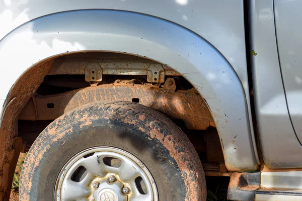 Stock image Abuja, Nigeria - June 20, 2023: Offroad Truck Driving against Muddy Terrain in African Communities.