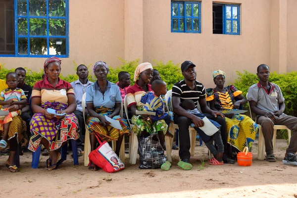 stock image Edo State, Nigeria - August 10, 2021: Africans sitting, queuing and Waiting for Free Medical Care and Attention in a Rural Community