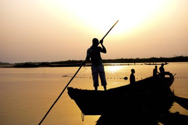 Delta State, Nijerya - 9 Aralık 2021: Afrika topluluklarında su taşımacılığı. Afrika nehirlerinin ticari kullanımı. Kırsal çevrede alım satım. Afrika Köylerinde Balıkçılık.