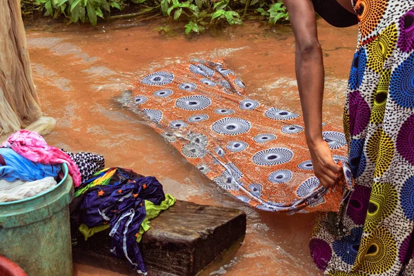 Stock image Delta State, Nigeria - December 9, 2021: African woman washing clothes in river, Nigeria