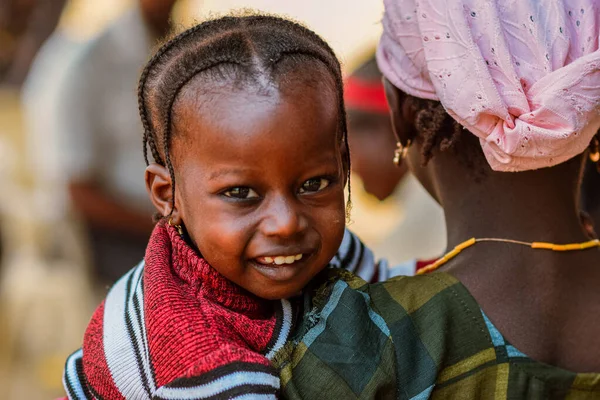Jos, Nijerya - 20 Ocak 2023: annesiyle birlikte bir Afrikalı çocuğun portresi. Afrikalı çocuklarla rastgele samimi anlar.