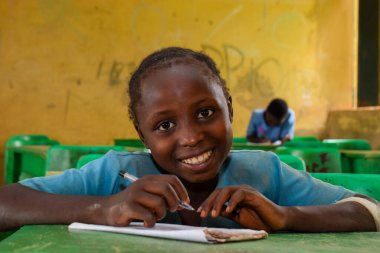 Abuja, Nijerya - 6 Haziran 2022: Kırsal Toplulukta Öğrenen Afrikalı Bir Çocuğun Portresi. Sınıfta üniforma giyen gülümseyen Afrikalı çocuklar. Afrika Köylerinde İlköğretim.