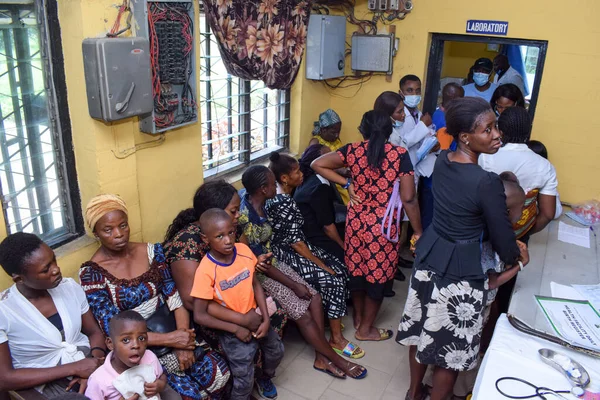 stock image Aluu, Port Harcourt - August 10, 2021: Africans people waiting for Free Medical Care and Attention in a Rural Community. People Register to Vote in Election. political Campaign Exercise
