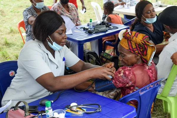 stock image Aluu, Port Harcourt - August 10, 2021: Africans people waiting for Free Medical Care and Attention in a Rural Community. People Register to Vote in Election. political Campaign Exercise