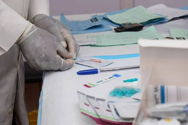 stock image Ikeja, Lagos State - October 5, 2021: African Laboratory Scientist Conducting Blood Screening in Rural Communities. Blood Test. Genotype, Strip Test. Covid-19 or Hemoglobin Test.