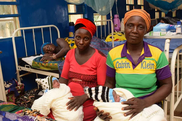 stock image Kachia, Kaduna State - September 6, 2021: African Mother Recovering on a Bed in a rural clinic After a Successful Caesarean Surgery Session. Delivery of a Set of Twin. Child Delivery in Africa.