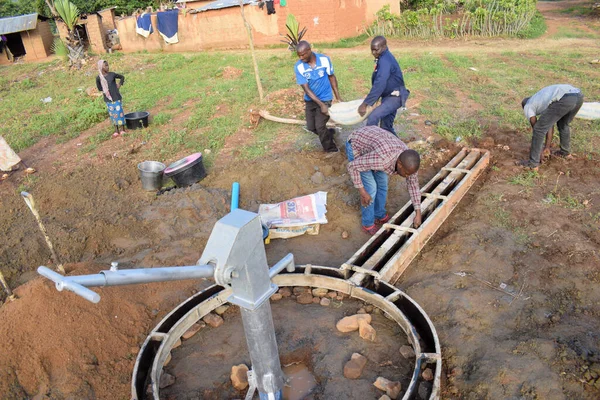 stock image Jos East, Plateau State, Nigeria - May 12, 2021: Hand Pump Water Well Installation in Rural Communities. SDG Goals in Nigeria Africa. Group of africans people working of installing hand pump water well.