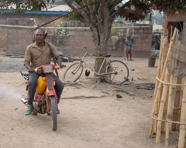 stock image Opialu, Benue State - March 6, 2021: African Farmer and Father Heading to the Farm on his motorbike