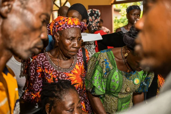 stock image Abuja, Nigeria - August 15, 2023: African sitting While Waiting on a Queue for Medical Care and Attention in a Rural Community. Political Campaign in Africa