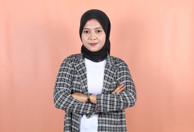 Kollarını kavuşturmuş ve şeftali tarlasında ciddi bir yüzü olan güzel Asyalı kadın.