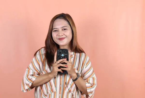 Mutlu Düşünceli Genç Bir Kadın Elinde Telefon Göğsüyle Gülümsüyor Şeftali — Stok fotoğraf
